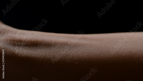 Macro shot of woman's good-looking white flawless smooth healthy soft pure arm skin on black background | Skin texture shot for skin nourishing concept