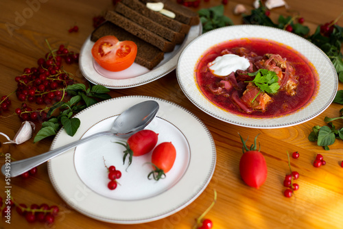 Beetroot soup called borsch with meat, potatos and cabbage and traditional russian black bread or rye bread