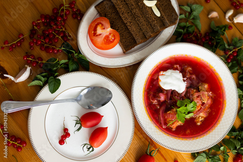 Beetroot soup called borsch with meat, potatos and cabbage and traditional russian black bread or rye bread