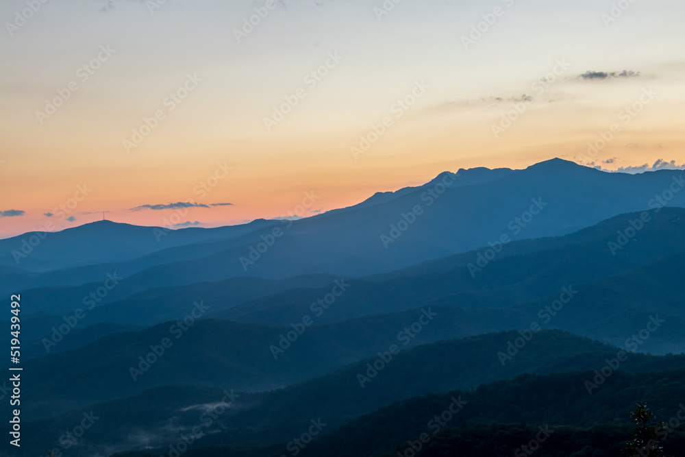 blue ridge mountains at sunset with orange and yellows. blue ridge mountains at sunset with orange and yellows.