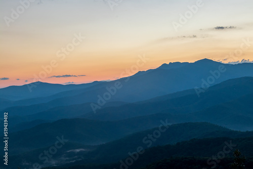 blue ridge mountains at sunset with orange and yellows.