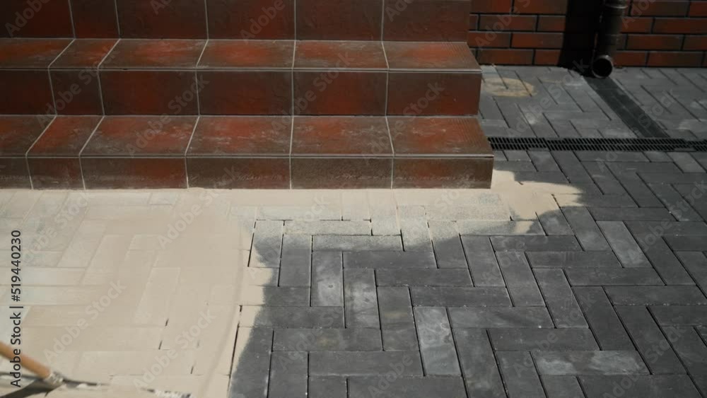 Closeup of sand on a new pavement for grouting between paving slabs
