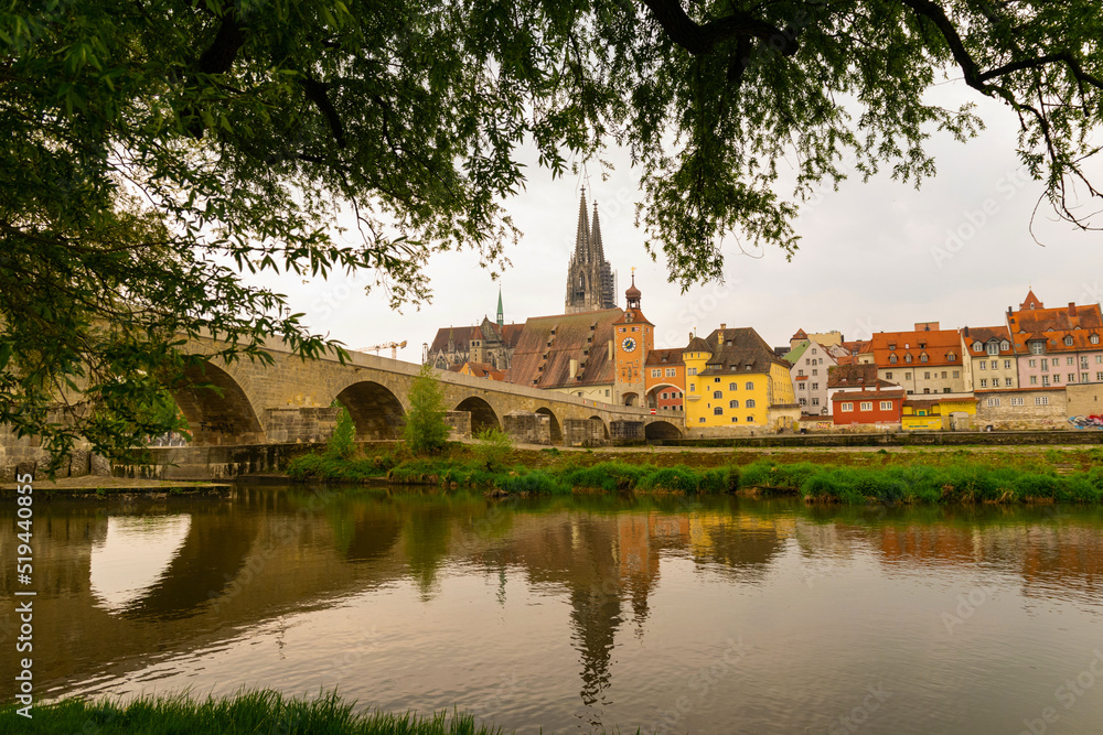 view over the river Danube to the old stone bridge and downtown Regensburg