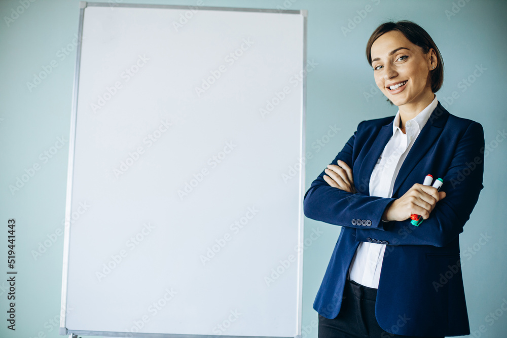 Business woman analyst standing by the white board at the office Business woman analyst standing by the white board at the office