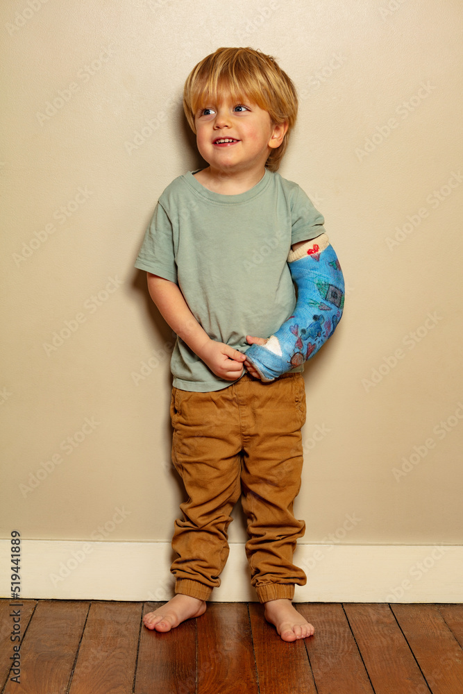 Portrait of a boy with positive expression despite broken hand