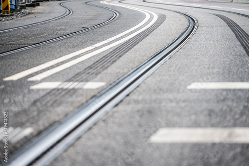 Tram track curve on asphalt road.