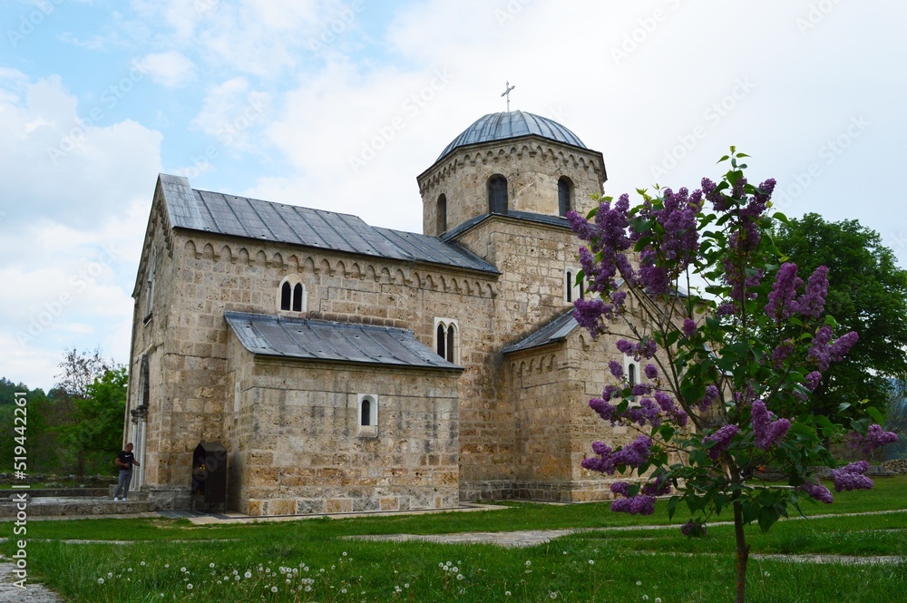 old stone orthodox monastery and lilac