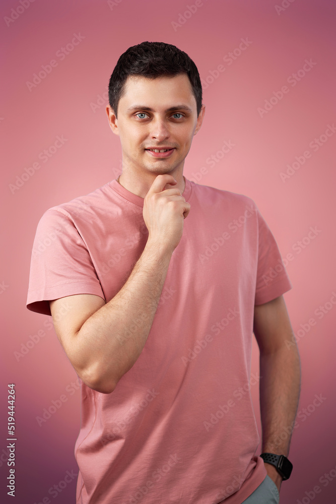 man holding arms folded, touching chin with hand man holding arms folded, touching chin with hand
