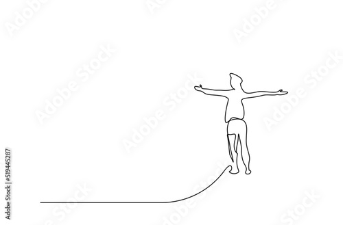 a young man climbs to the top with open arms and looks at the skyline happily and hopefully