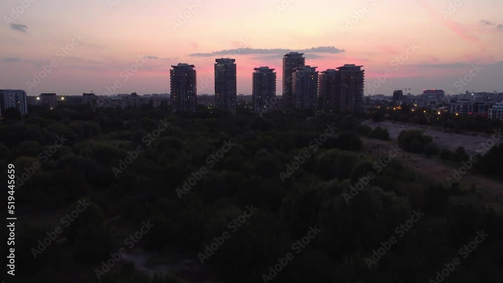 After sunset aerial view of Bucharest city skyline from Vacaresti Delta with high buildings in the middle and People's House and lots of the city landmarks in background After sunset aerial view of Bucharest city skyline from Vacaresti Delta with high buildings in the middle and People's House and lots of the city landmarks in background