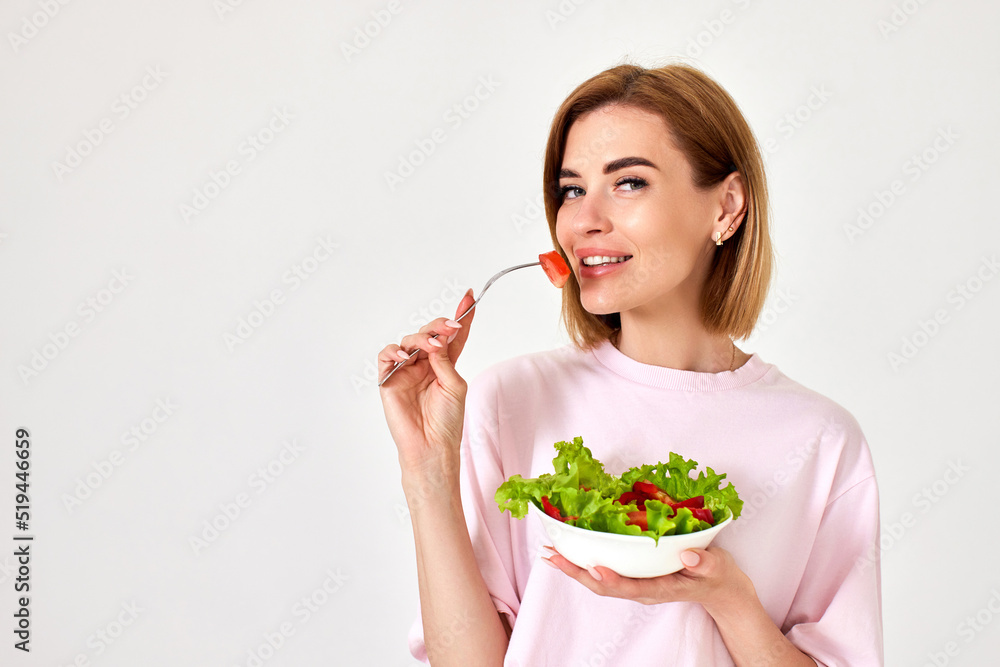 beautiful woman eating fresh vegetable salad on white background beautiful woman eating fresh vegetable salad on white background