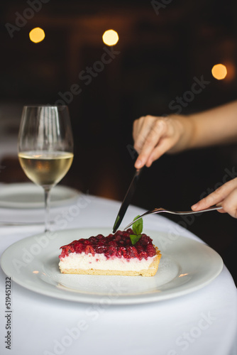 Tart with raspberry coulis. Dessert on a white plate