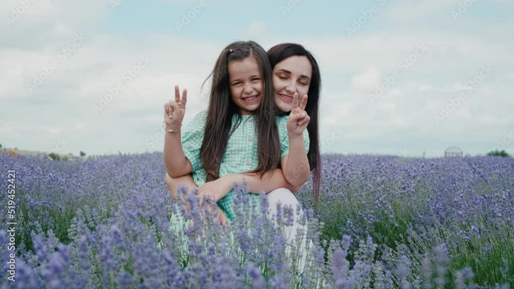 Happy mother playing with children in lavender field. Emotions and smiles of children.The family spends leisure.Children are having fun playing.Happy cheerful family in nature, weekend Happy mother playing with children in lavender field. Emotions and smiles of children.The family spends leisure.Children are having fun playing.Happy cheerful family in nature, weekend