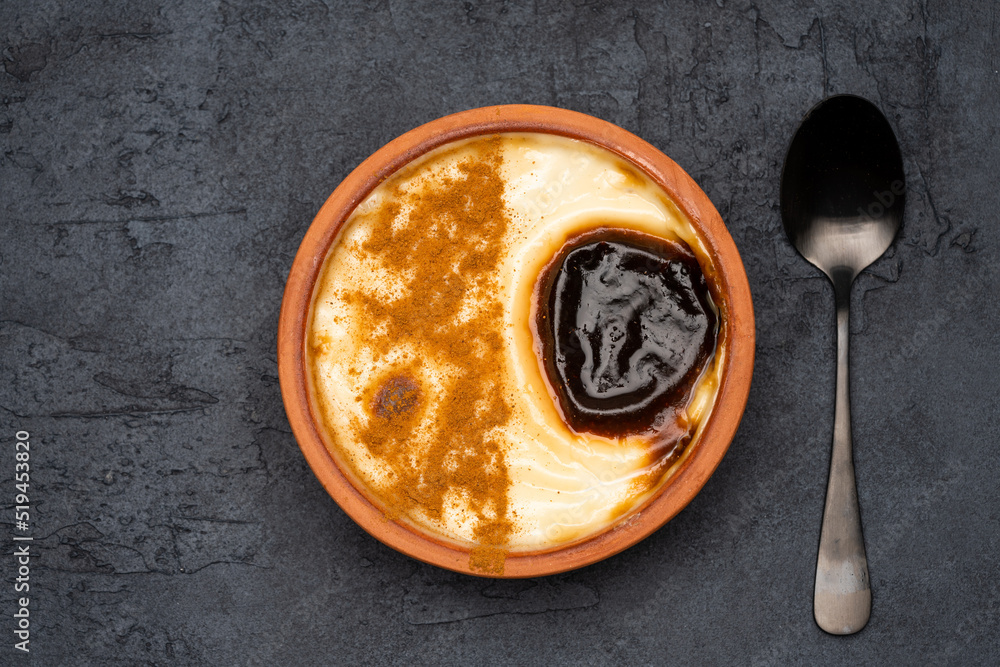 Turkish dessert. Rice pudding with cinnamon on the vintage background Turkish dessert. Rice pudding with cinnamon on the vintage background
