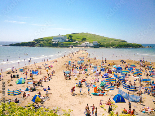 Tourists sunbathe in front of Burgh Island Hotel in Devon, England