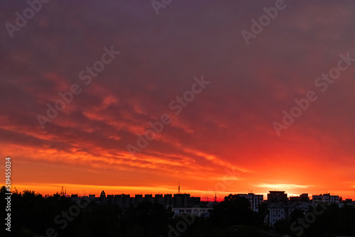 Beautiful clouds in early morning. Sun rising over city.