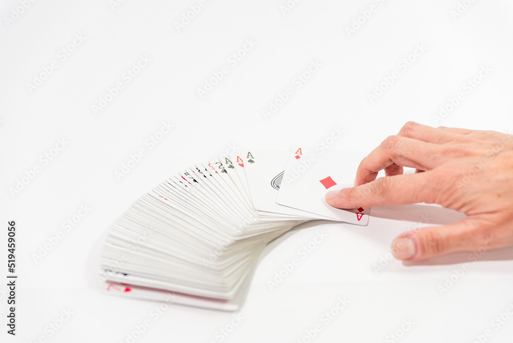 hand holding a card, open cards on the table hand holding a card, open cards on the table