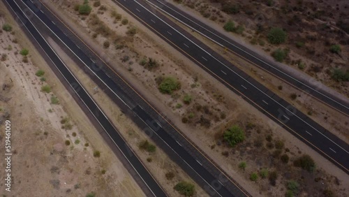 A cinematic aerial drone shot looking straight down over the Bush highway interchange along Arizona's Beeline highway (Highway 87).