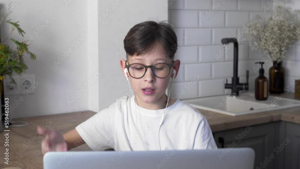 A boy with glasses and headphones in an online lesson. Distance education. Study A boy with glasses and headphones in an online lesson. Distance education. Study