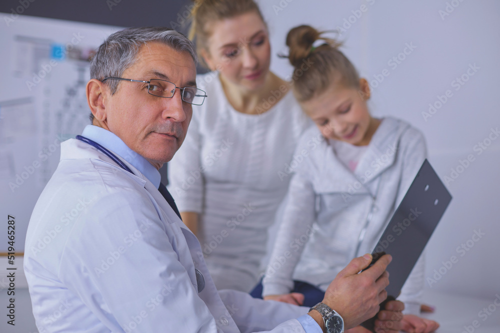 Little girl with her mother at a doctor on consultation Little girl with her mother at a doctor on consultation