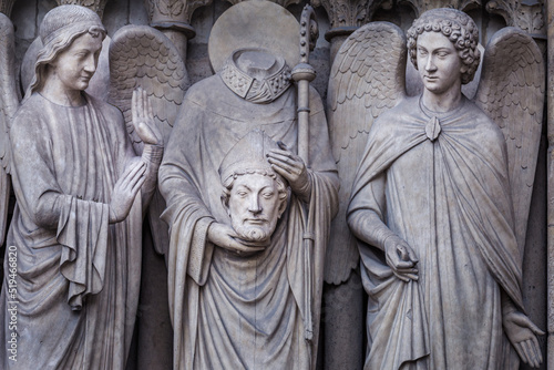 Saint Denis without head and angel, Notre dame detail, Paris, France