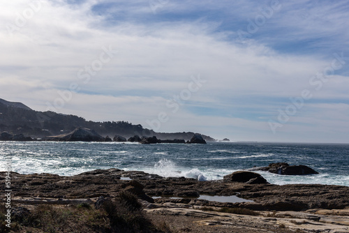 A view on Pacific ocean coast with rocks and waves