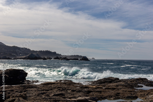 A view on Pacific ocean coast with rocks and waves