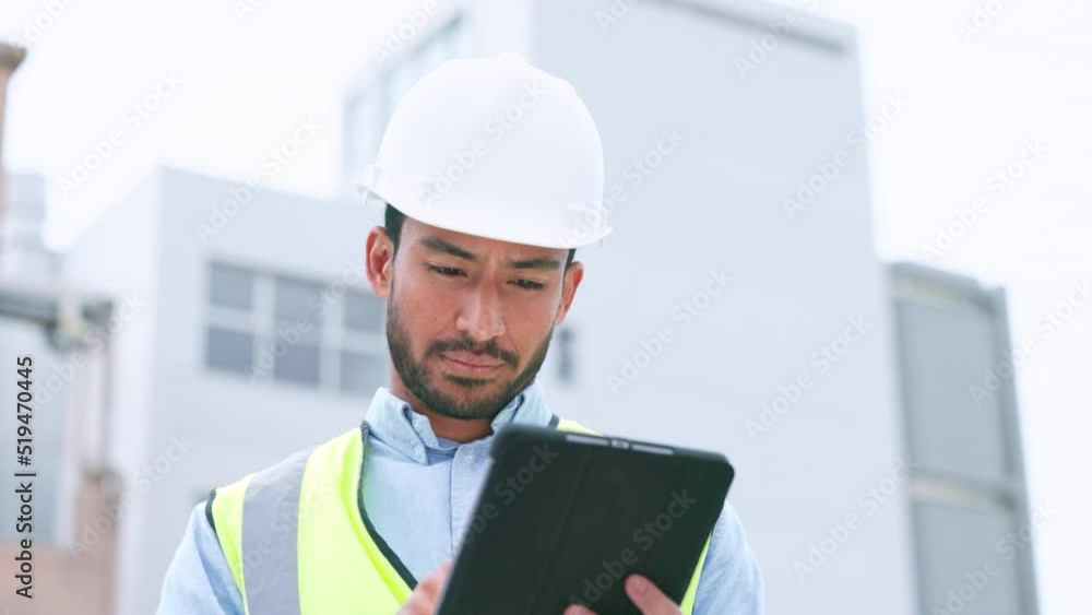 Thinking, content construction engineer typing on a tablet while onsite for inspection. Male architect or technician supervisor looking at operations while checking project plan using technology Thinking, content construction engineer typing on a tablet while onsite for inspection. Male architect or technician supervisor looking at operations while checking project plan using technology