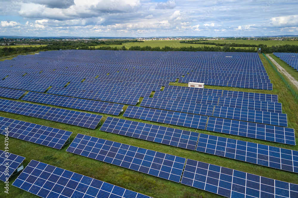 Aerial view of big sustainable electric power plant with many rows of solar photovoltaic panels for producing clean electrical energy. Renewable electricity with zero emission concept Aerial view of big sustainable electric power plant with many rows of solar photovoltaic panels for producing clean electrical energy. Renewable electricity with zero emission concept
