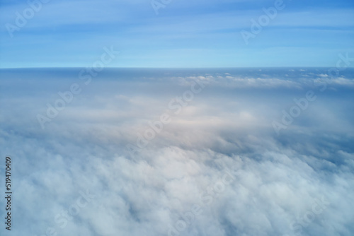 Aerial view from high altitude of earth covered with puffy rainy clouds forming before rainstorm © bilanol