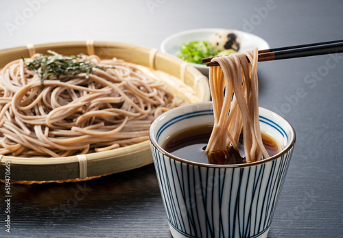 Zaru-soba placed on a black background. Soba noodles dipped in noodle soup.