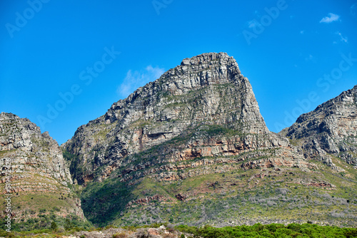 Landscape, mountain view and blue sky of Twelve Apostles with copy space in remote countryside hiking terrain. Scenery of famous landmark in an environmental nature reserve in Cape Town, South Africa