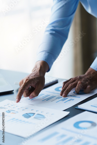 Businessman analysis maketing plan, Accountant calculate financial report, computer with graph chart. Business, Finance and Accounting concepts
