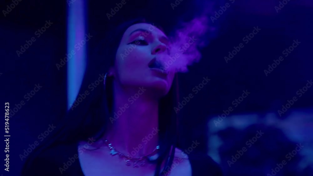 Close-up of a girl in a club, dancing and smoking an electronic cigarette. Night club Close-up of a girl in a club, dancing and smoking an electronic cigarette. Night club