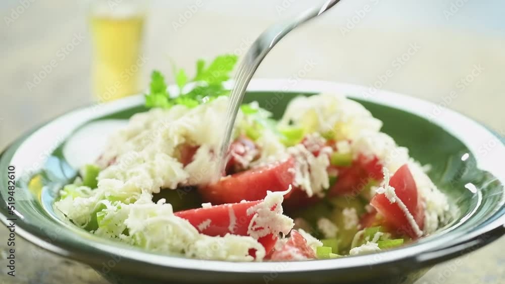 Eating traditional bulgarian Shopska salad.
