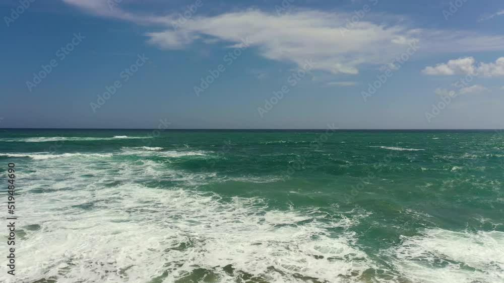 Ocean with waves on a background of blue sky and clouds. Summer and travel vacation concept Ocean with waves on a background of blue sky and clouds. Summer and travel vacation concept