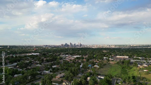 Downtown Denver skyline aerial timelapse moving towards city from suburb in south Denver metro area. Drone hyperlapse filmed in Lakewood, Colorado. photo