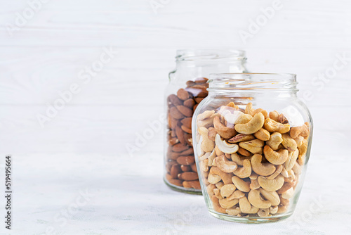 Cashew and almonds nuts in a jar. Set of nuts isolated on white background