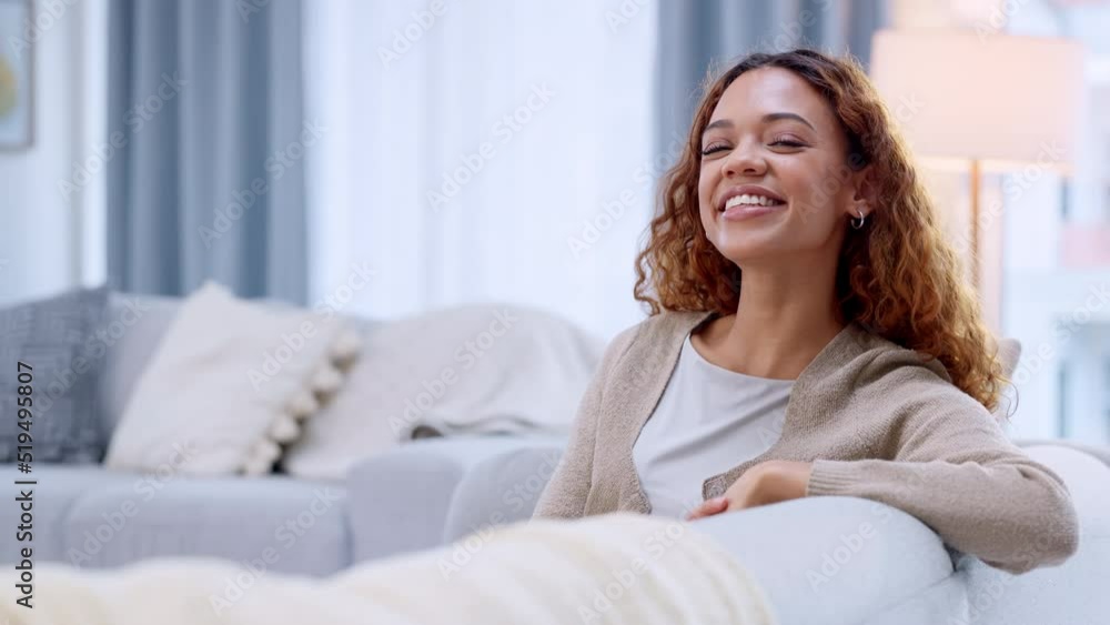 Happy, carefree and smiling girl relaxing on sofa in her living room. Portrait of African American teen having a lazy afternoon at home. Joyful and excited to be on vacation after final exams Happy, carefree and smiling girl relaxing on sofa in her living room. Portrait of African American teen having a lazy afternoon at home. Joyful and excited to be on vacation after final exams