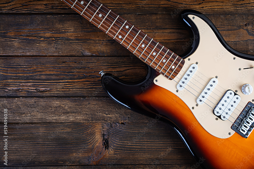 Obraz premium Close-up on electric guitar on vintage old wooden background