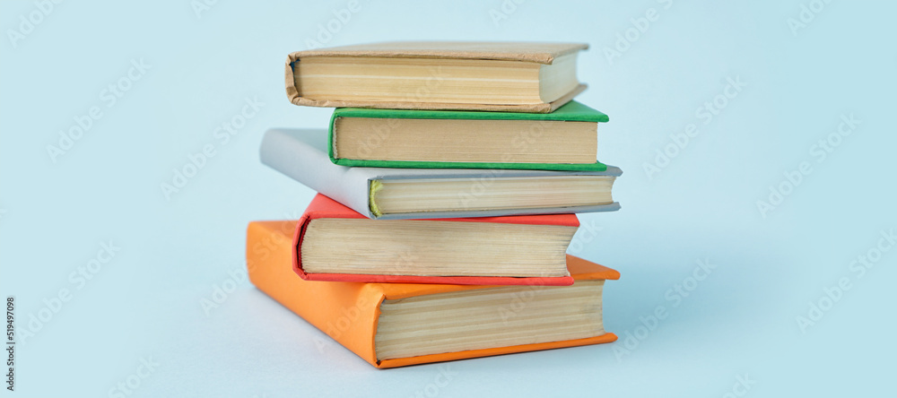 Stack of books on light blue background Stack of books on light blue background