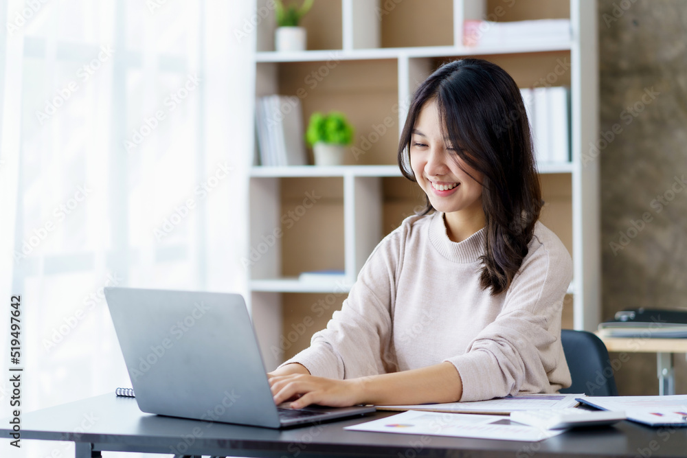 Beautiful young Asian woman student studying online with laptop computer at home. Beautiful young Asian woman student studying online with laptop computer at home.