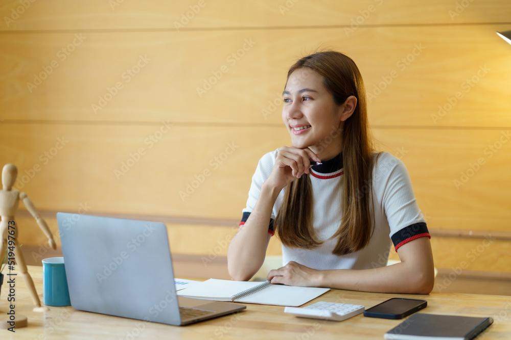 Beautiful young Asian woman student studying online with laptop computer at home. Beautiful young Asian woman student studying online with laptop computer at home.