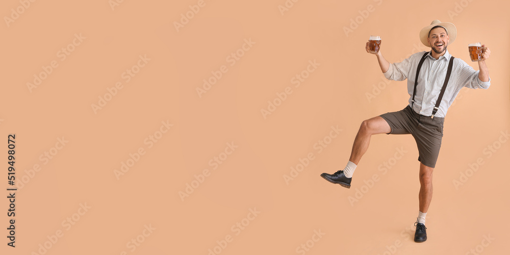 Happy man in traditional German clothes with beer on beige background with space for text