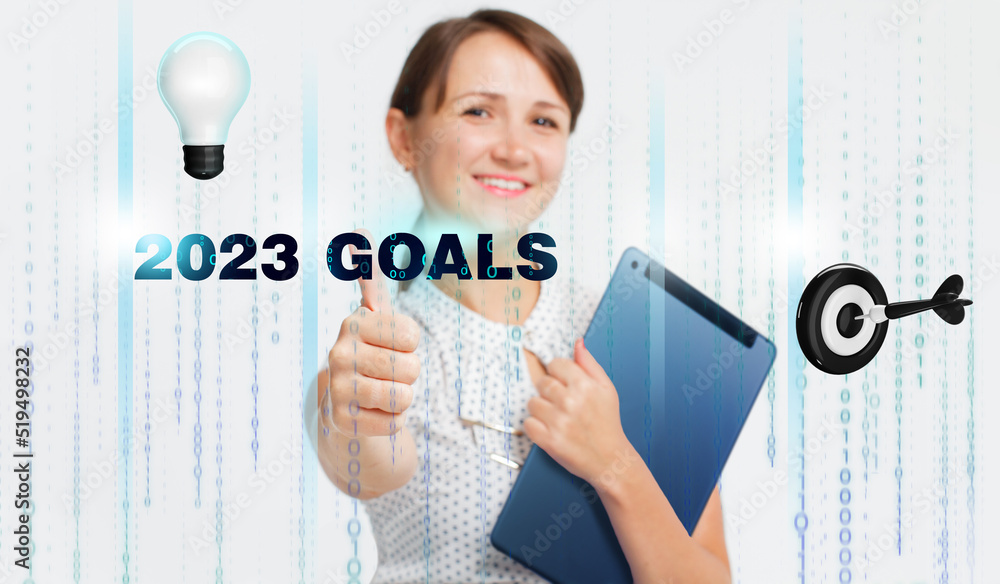Business, Technology, Internet and network concept. Young businessman working on a virtual screen of the future and sees the inscription: 2023 goals Business, Technology, Internet and network concept. Young businessman working on a virtual screen of the future and sees the inscription: 2023 goals
