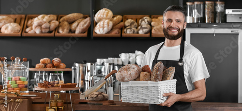 Male baker holding basket w...