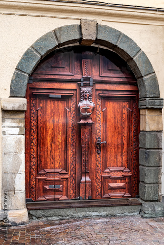 Renovation of a door in antic wooden look . New decorative surface due to sheathing. PVC Coated Doors