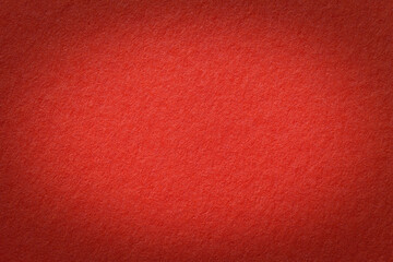 Texture of vintage red paper gradient background with dark vignette. Structure of craft ruby cardboard with frame.