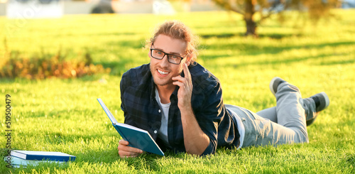 Handsome man reading book i...
