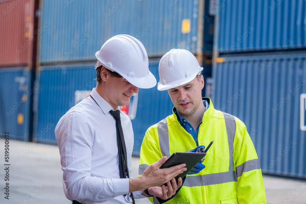Engineer and inspector working and discuss in shipping container in Container Terminal. Engineer and inspector working and discuss in shipping container in Container Terminal.